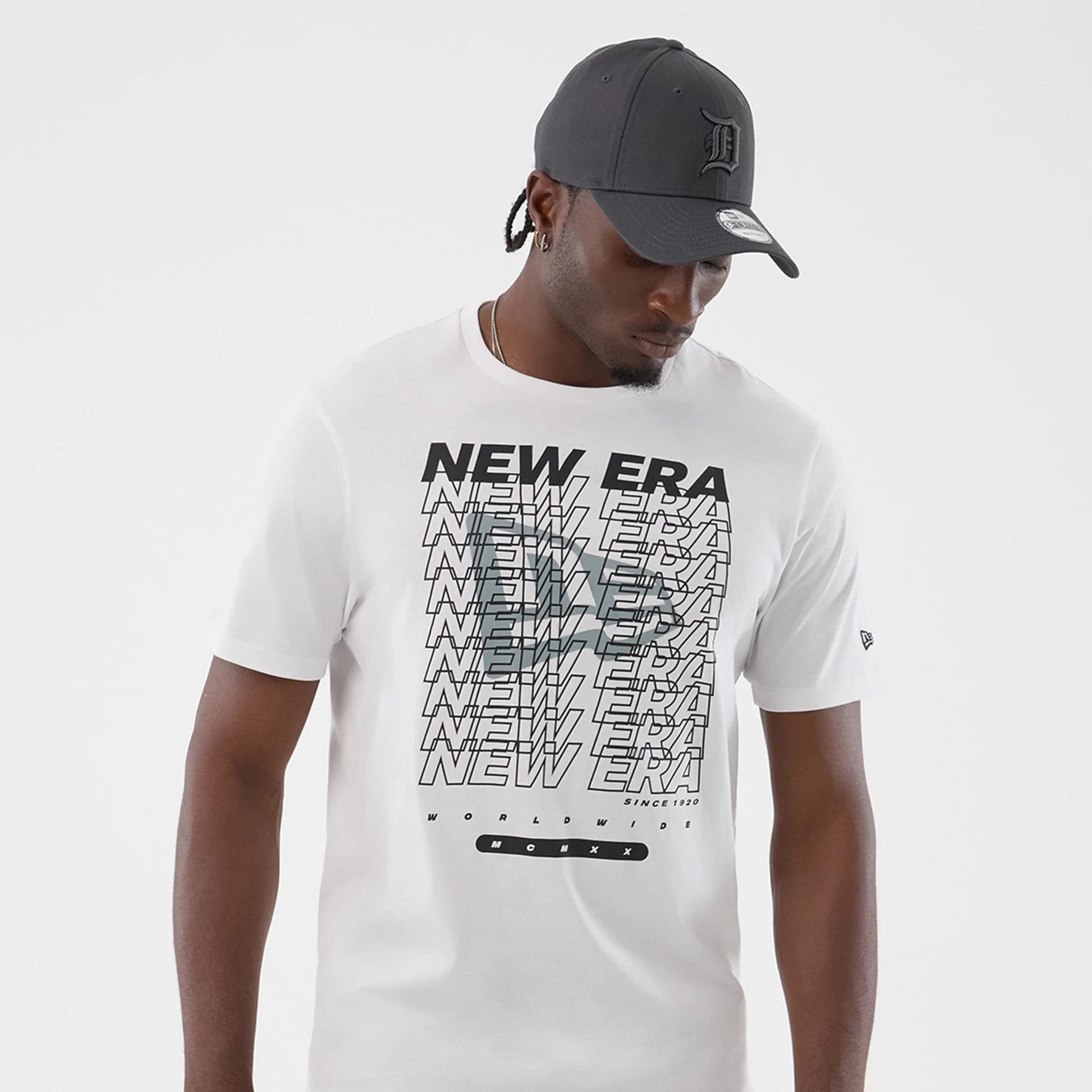 The model is wearing this New Era Logo Graphic T-Shirt in white. 3
