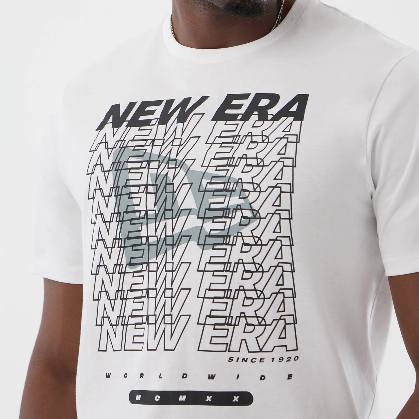 The model is wearing this New Era Logo Graphic T-Shirt in white. 4