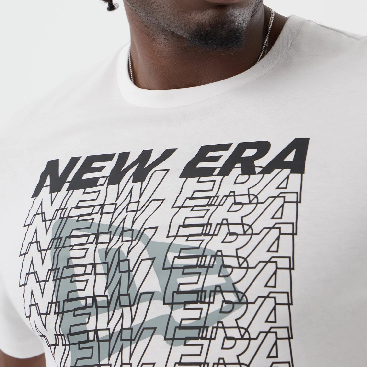 The model is wearing this New Era Logo Graphic T-Shirt in white. 6