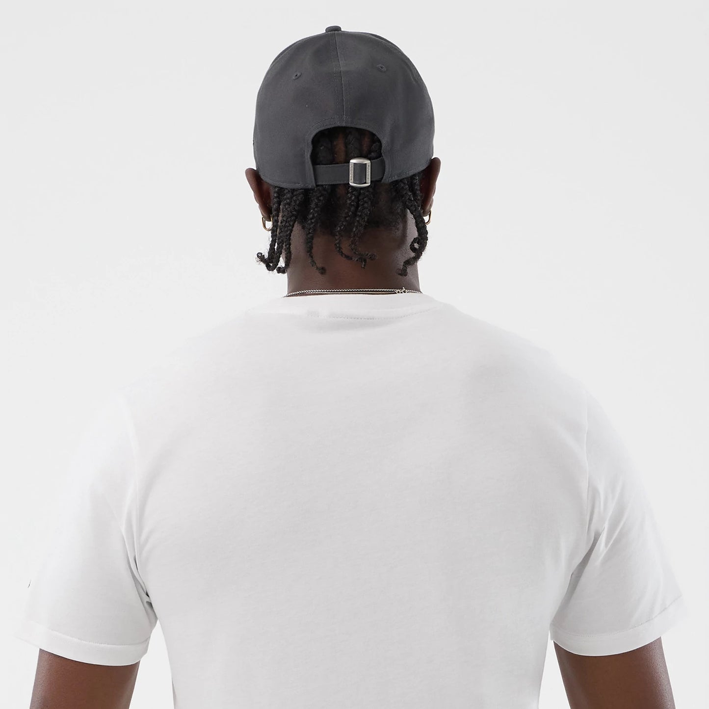 The model is wearing this New Era Logo Graphic T-Shirt in white. 7