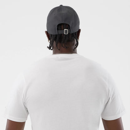 The model is wearing this New Era Logo Graphic T-Shirt in white. 7
