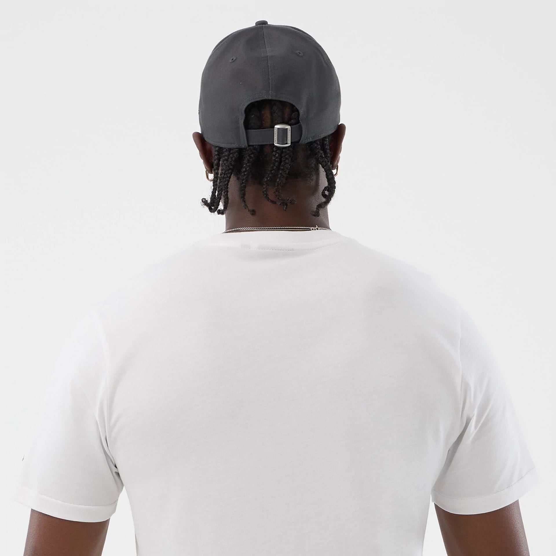 The model is wearing this New Era Logo Graphic T-Shirt in white. 7