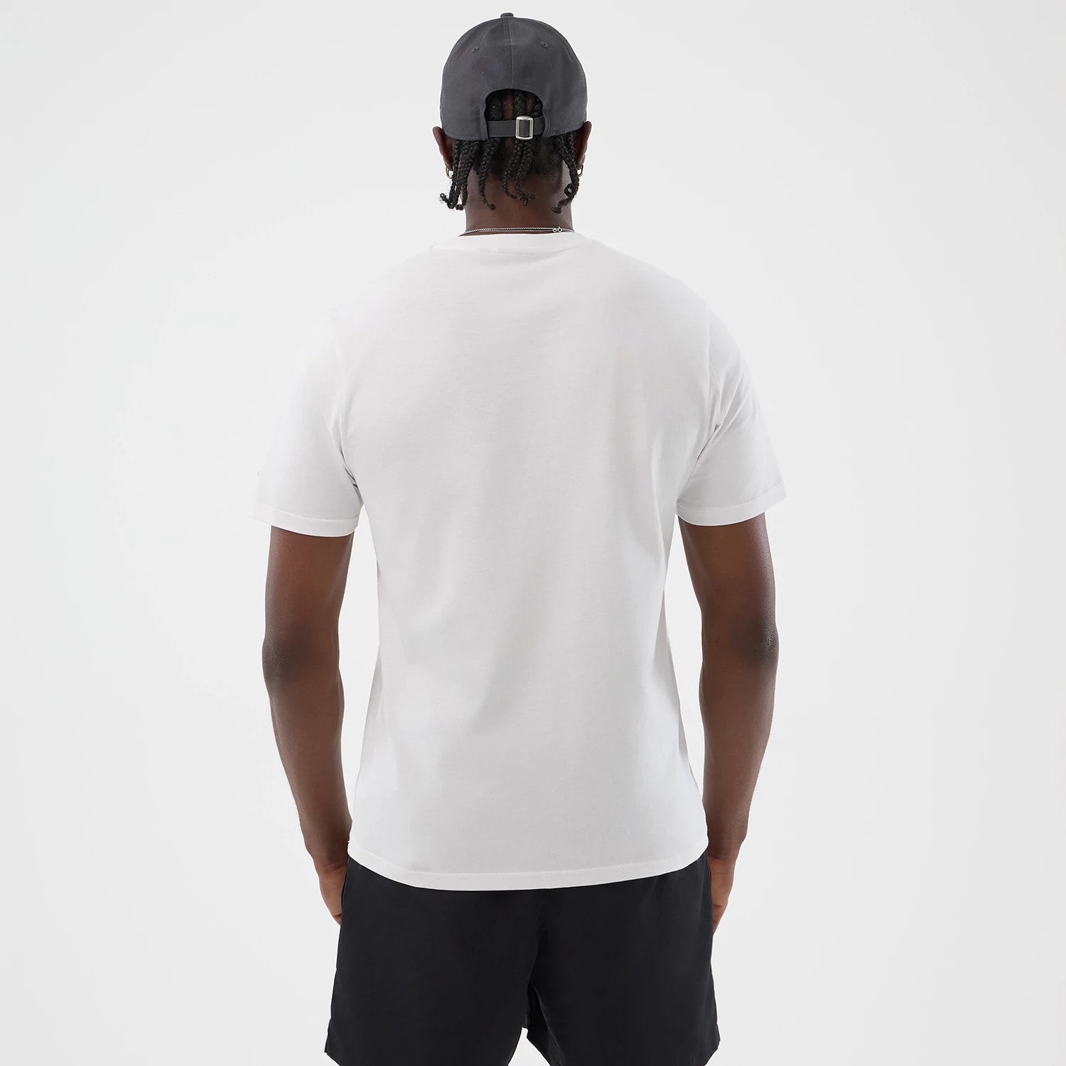 The model is wearing this New Era Logo Graphic T-Shirt in white. 2