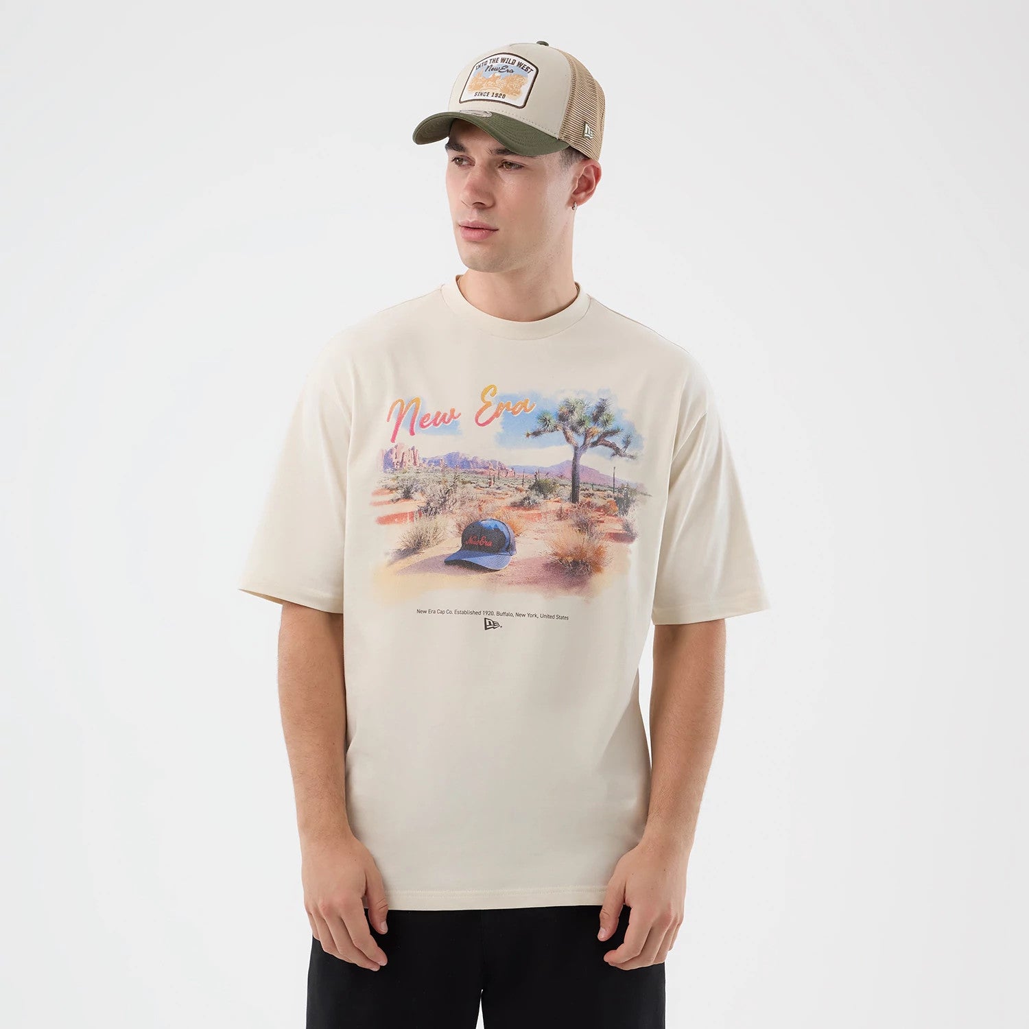 The model is wearing this New Era Dessert Graphic Oversized T-Shirt in light beige. 3