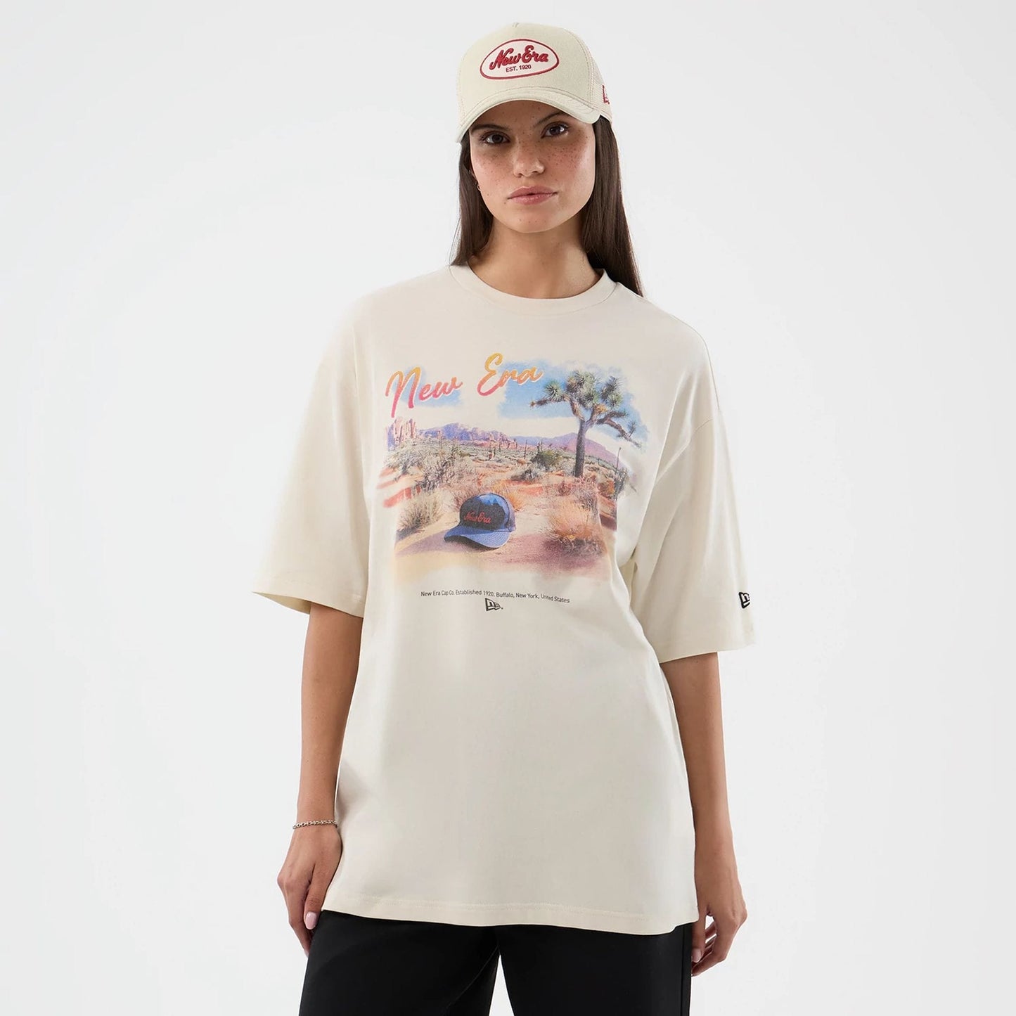 The model is wearing this New Era Dessert Graphic Oversized T-Shirt in light beige. 4