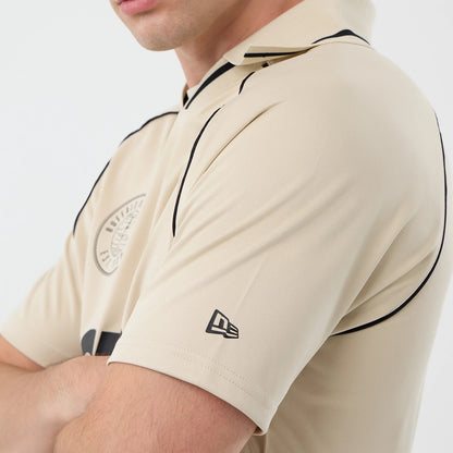 The model is wearing this New Era Football T-Shirt in light beige. 5