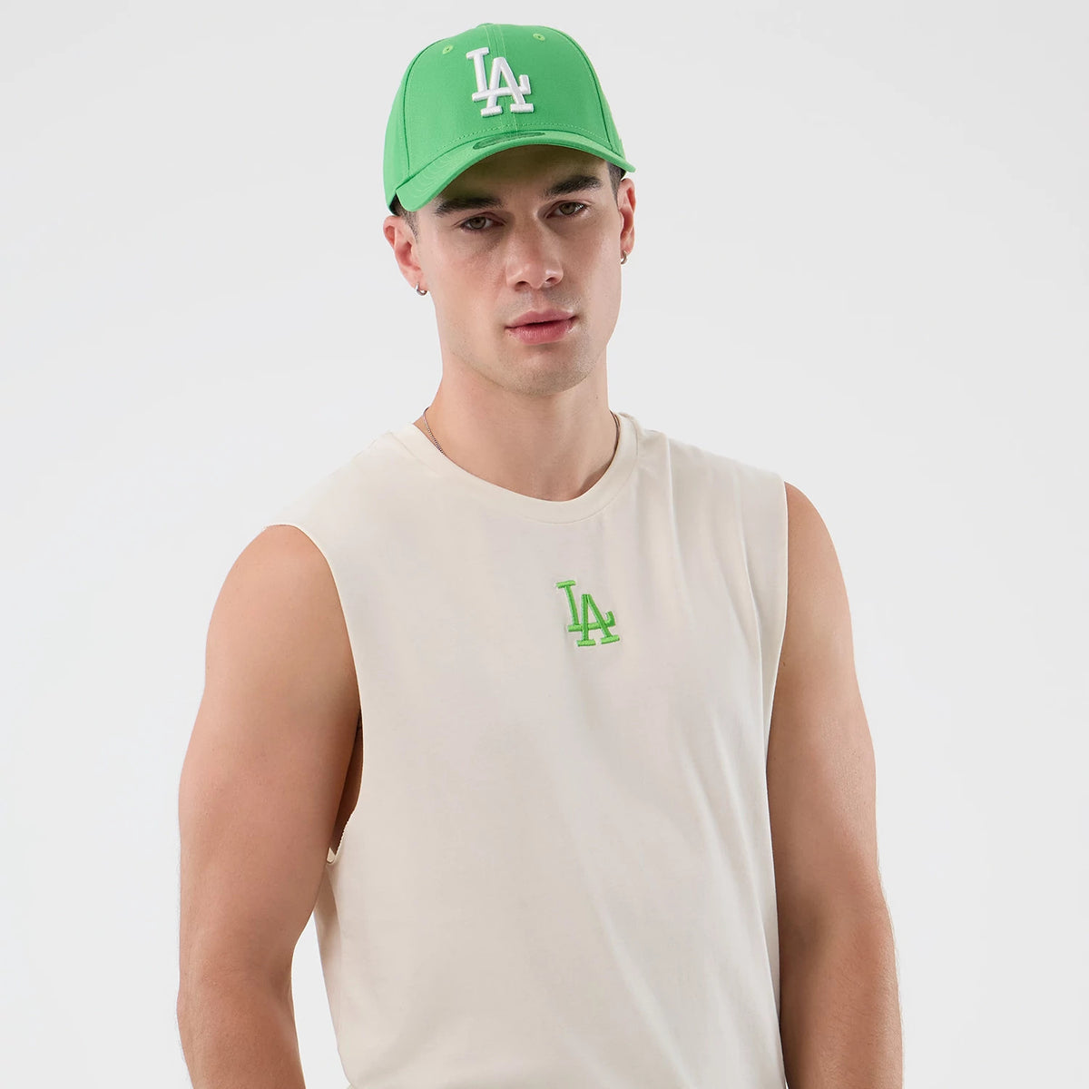 The model is wearing this MLB League Essential LA Dodgers Vest in open white. 3