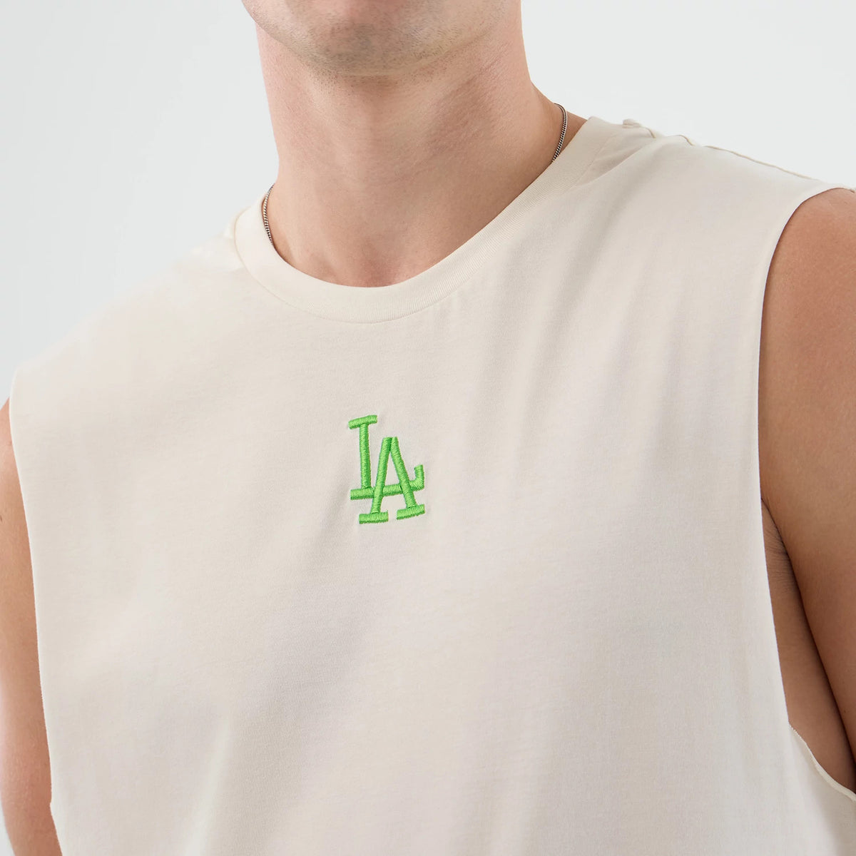 The model is wearing this MLB League Essential LA Dodgers Vest in open white. 4