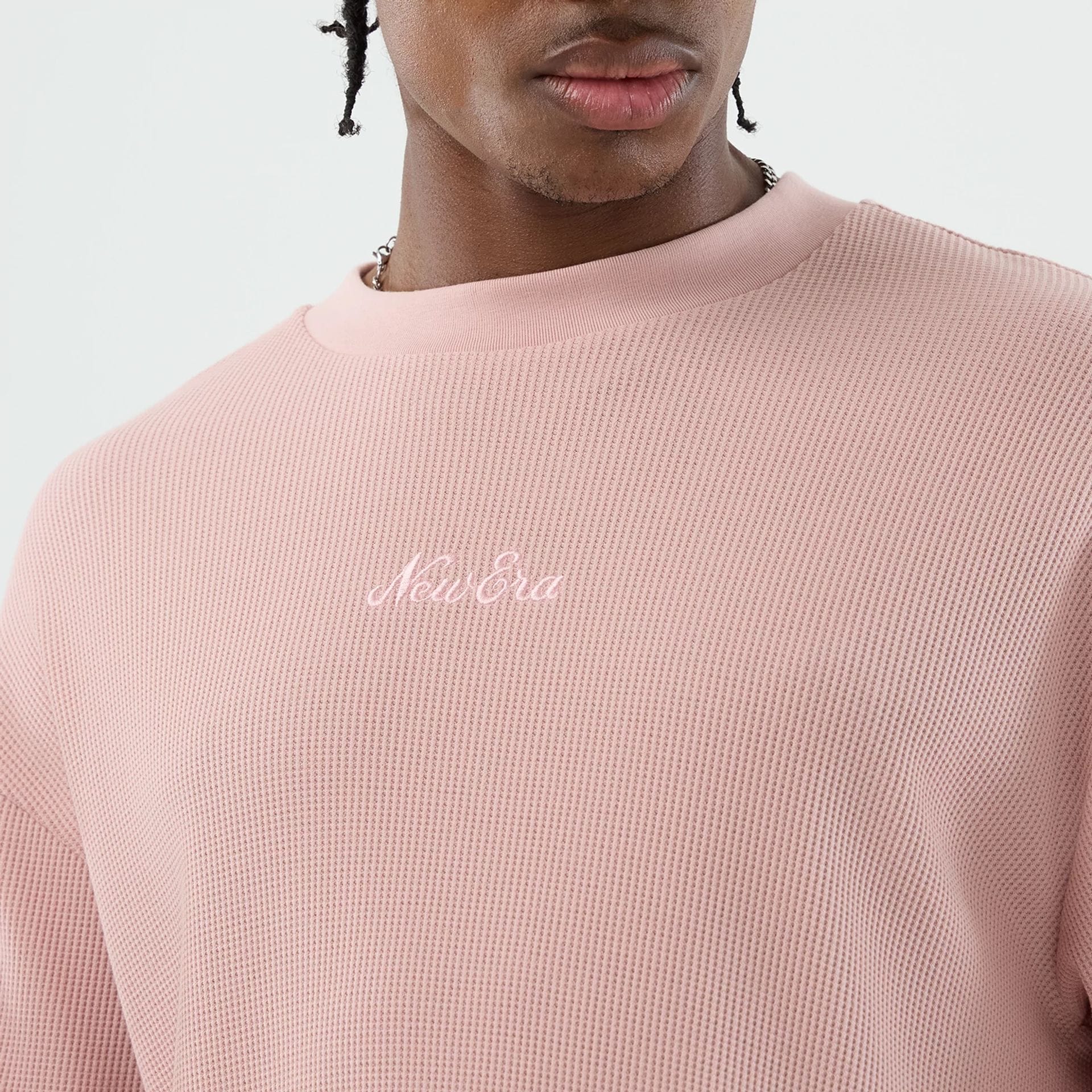 The model is wearing this New Era Waffle T-Shirt in pastel pink. 5