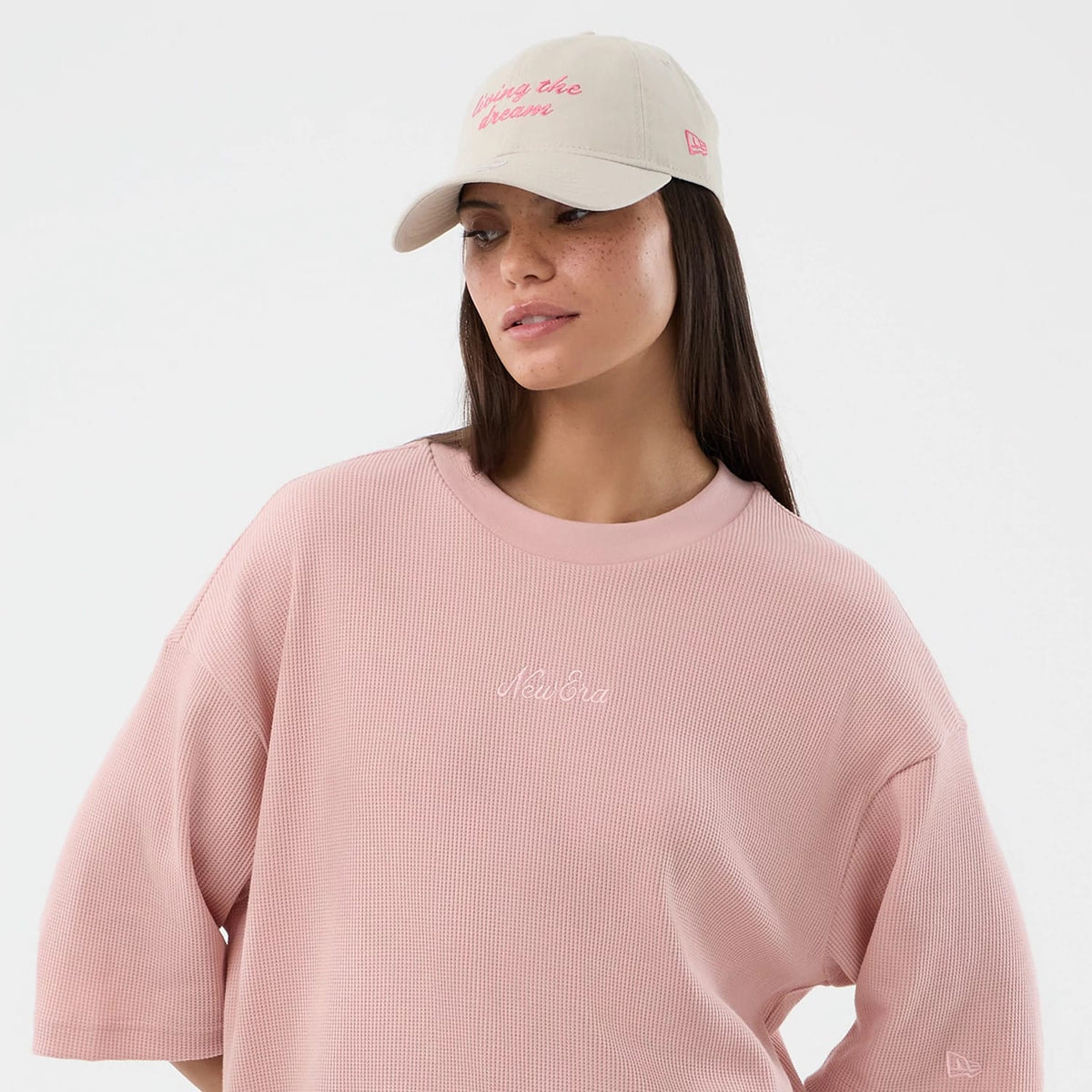The model is wearing this New Era Waffle T-Shirt in pastel pink. 6