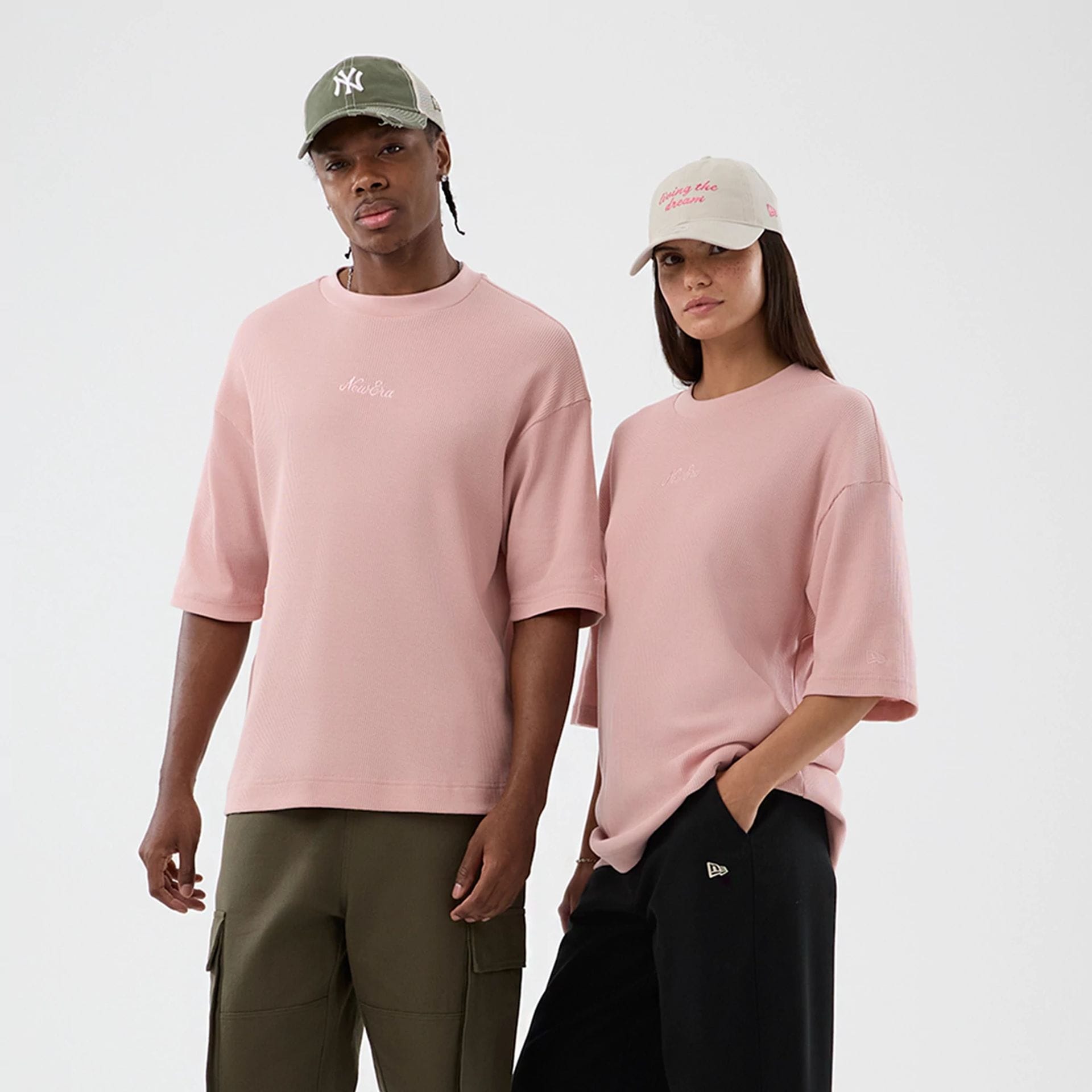 The model is wearing this New Era Waffle T-Shirt in pastel pink. 1