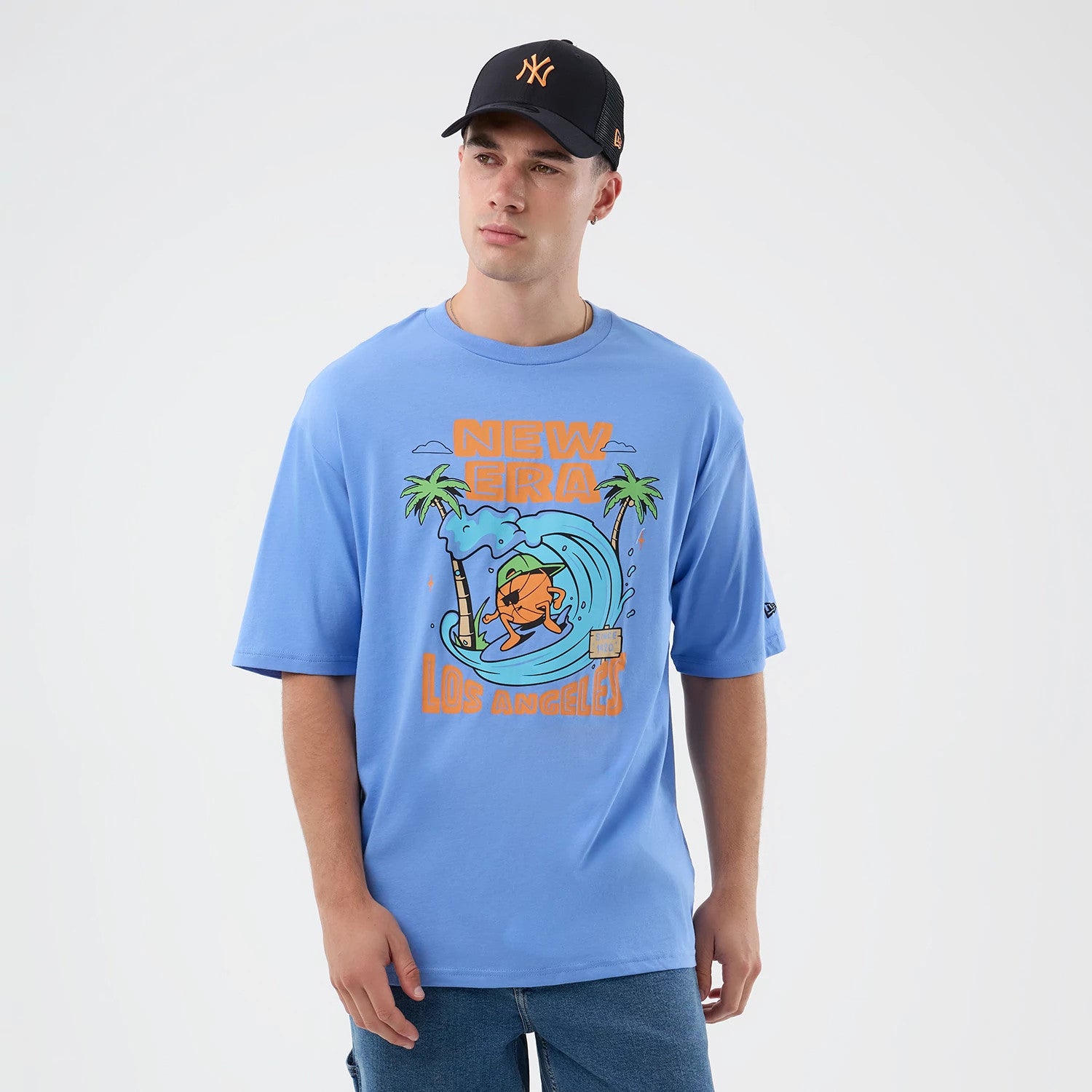 The model is wearing this New Era Basketball Character Graphic T-Shirt in pastel blue. 3