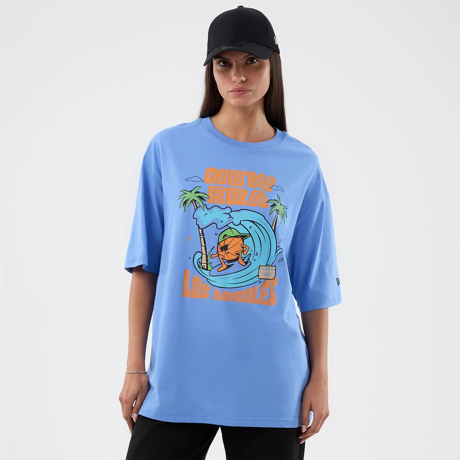 The model is wearing this New Era Basketball Character Graphic T-Shirt in pastel blue. 4