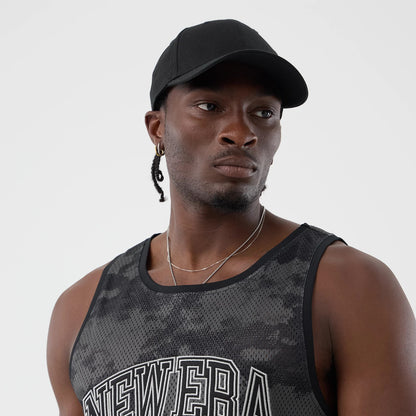 The model is wearing this New Era All Over Print Mesh Tank Top in black camo. 6
