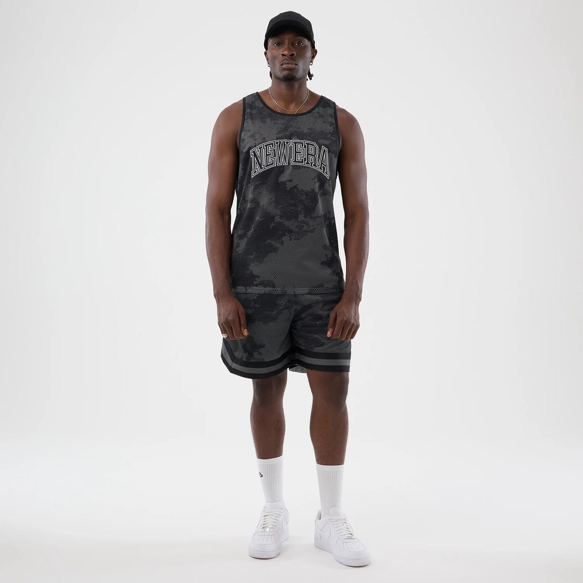 The model is wearing this New Era All Over Print Mesh Tank Top in black camo. 8