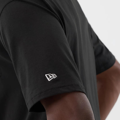 The model is wearing this New Era Serpent Graphic Oversized T-Shirt in black. 5