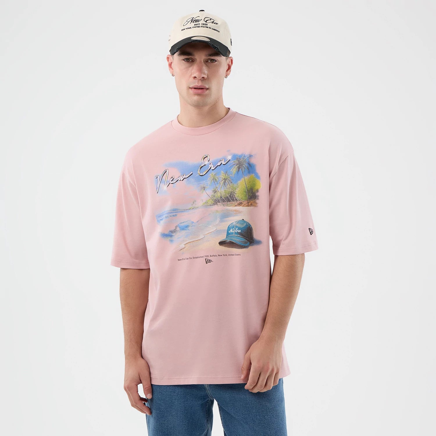 The model is wearing this New Era Beach Graphic Oversized T-Shirt in pastel pink. 3