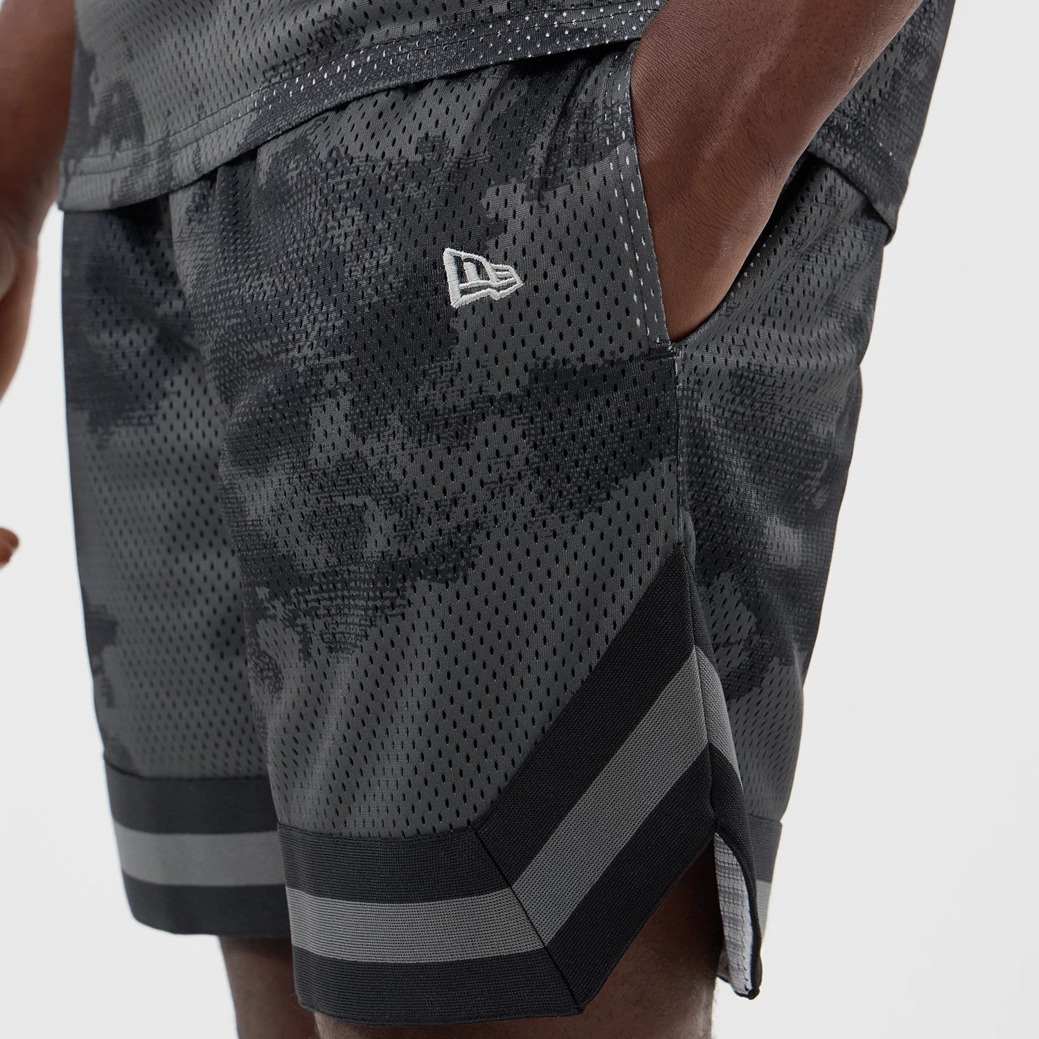 The model is wearing this New Era All Over Print Mesh Shorts in black camo. 4