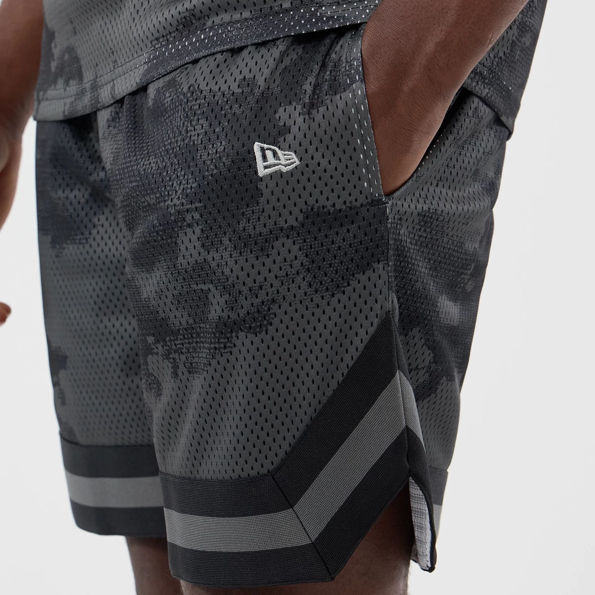 The model is wearing this New Era All Over Print Mesh Shorts in black camo. 4