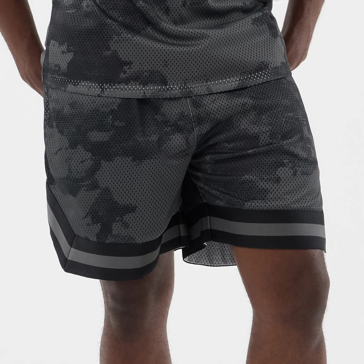 The model is wearing this New Era All Over Print Mesh Shorts in black camo. 5