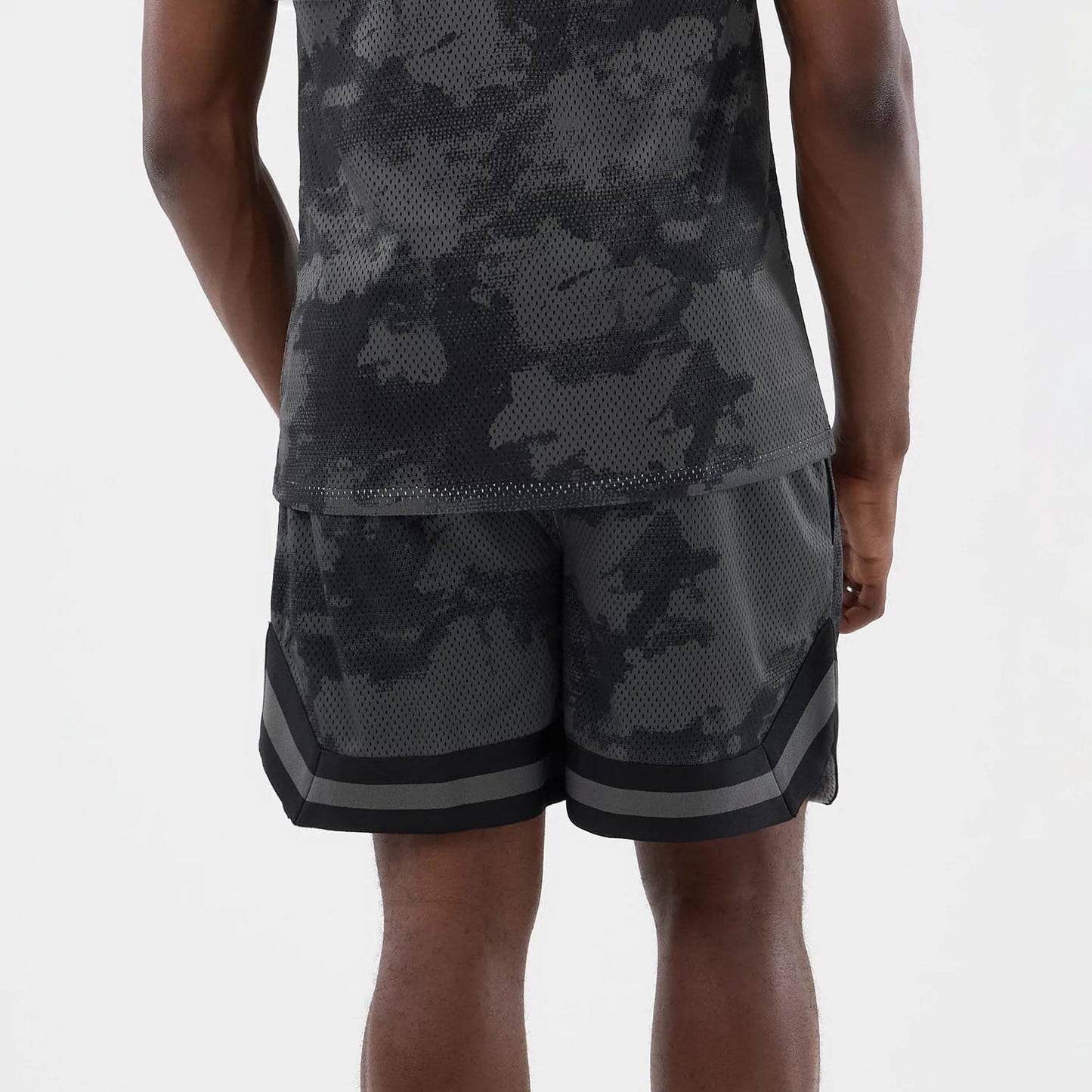 The model is wearing this New Era All Over Print Mesh Shorts in black camo. 6