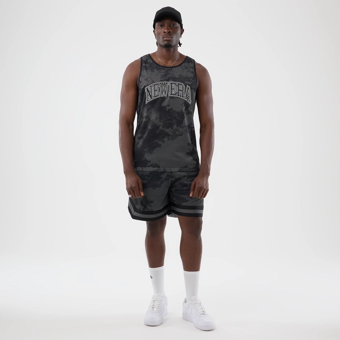 The model is wearing this New Era All Over Print Mesh Shorts in black camo. 7