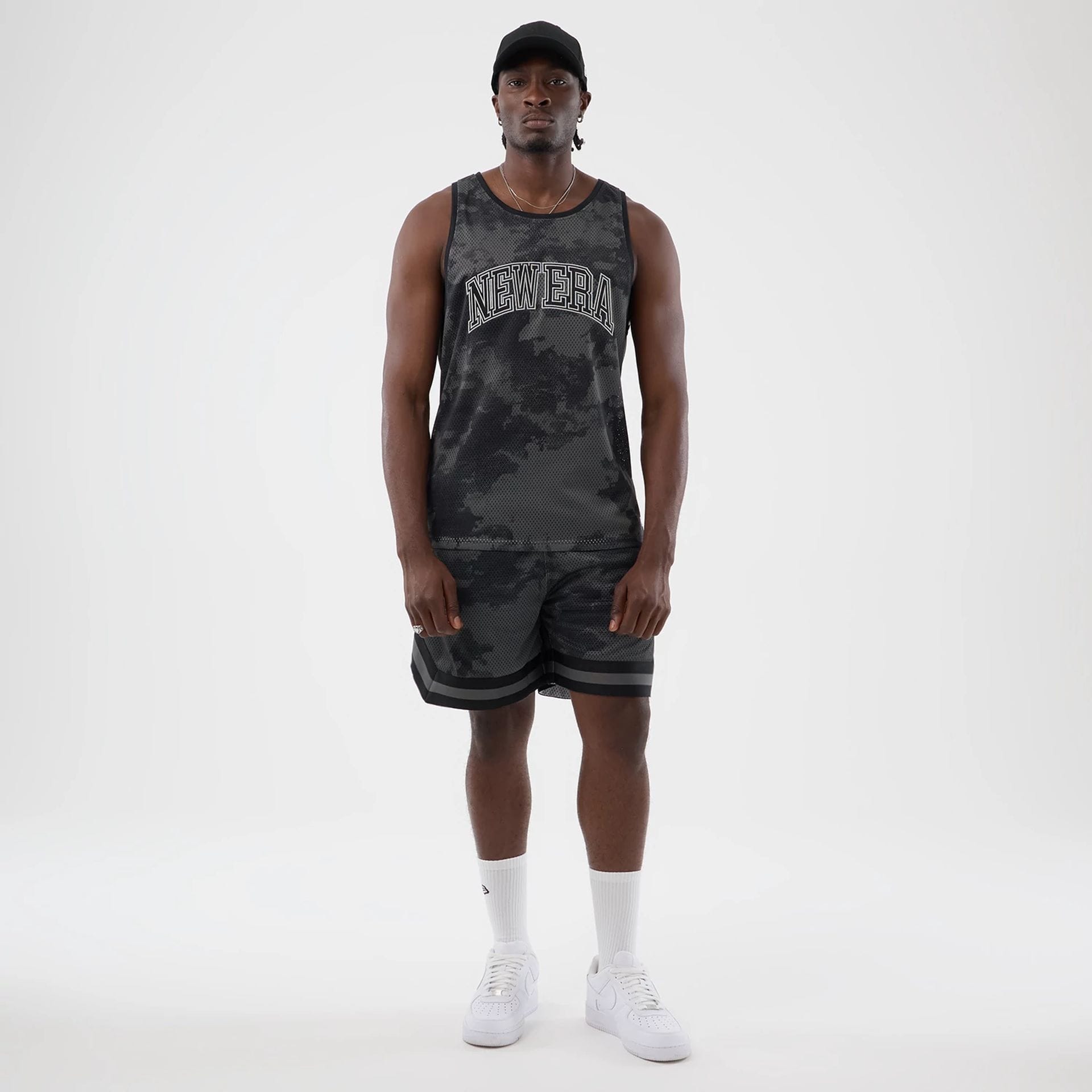 The model is wearing this New Era All Over Print Mesh Shorts in black camo. 7