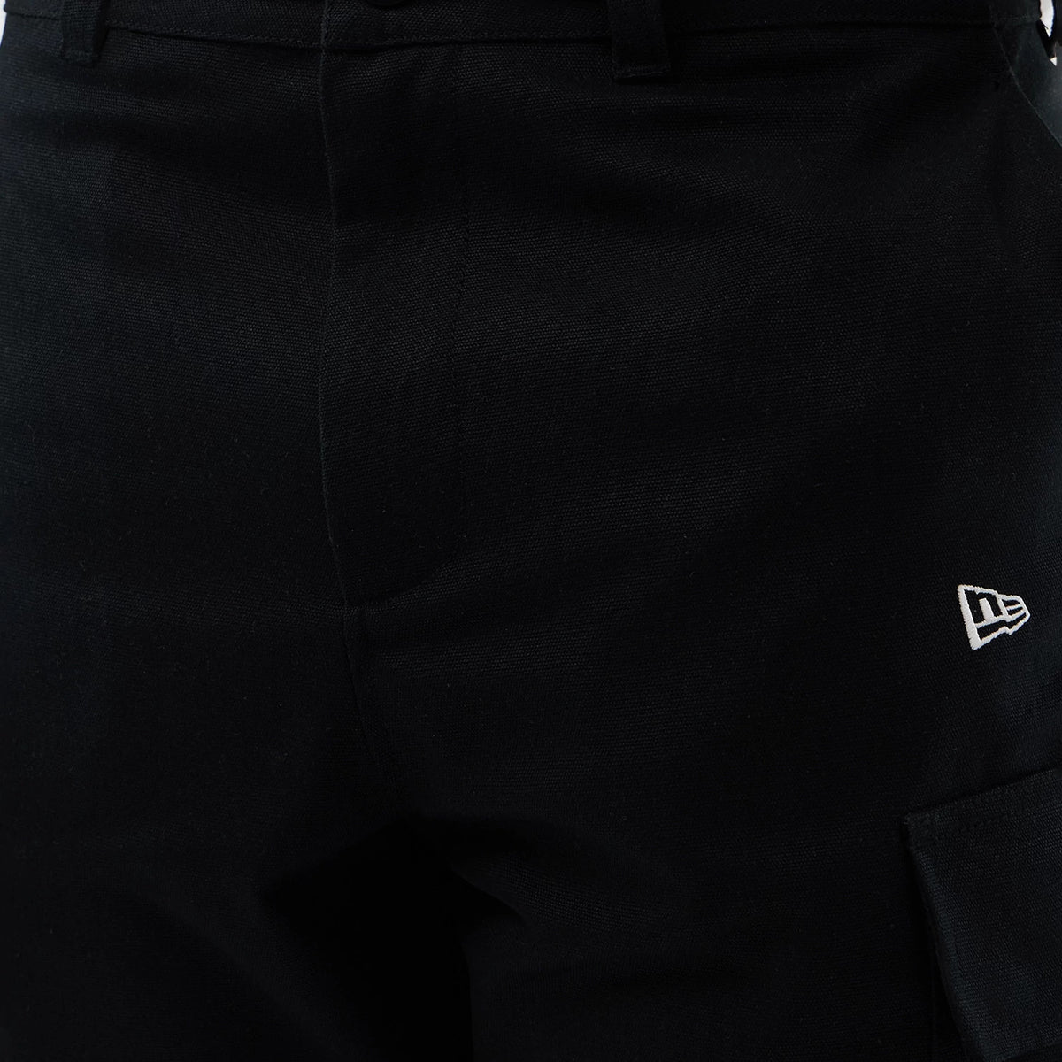 New Era Black Cargo Shorts, close-up view showing the waistband with belt loops, a seam at the centre, and a white embroidered New Era logo on the right side above a large cargo pocket.