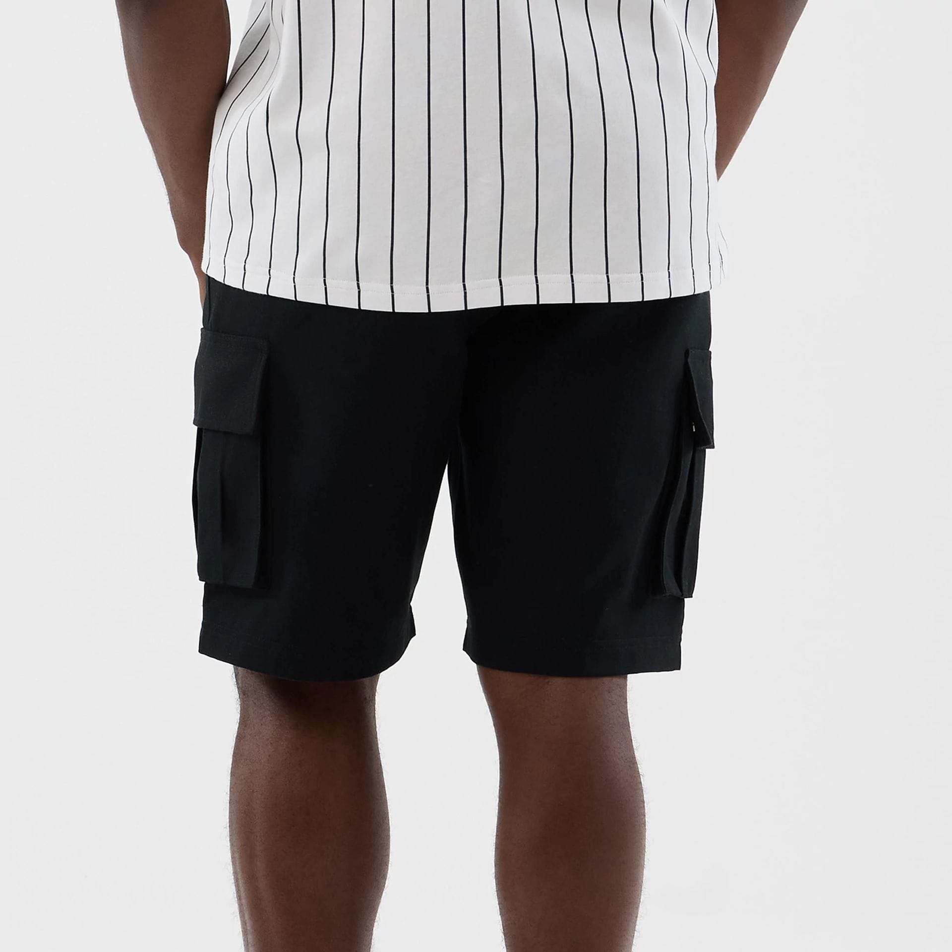 The model is wearing this New Era Cargo Shorts in black. 7
