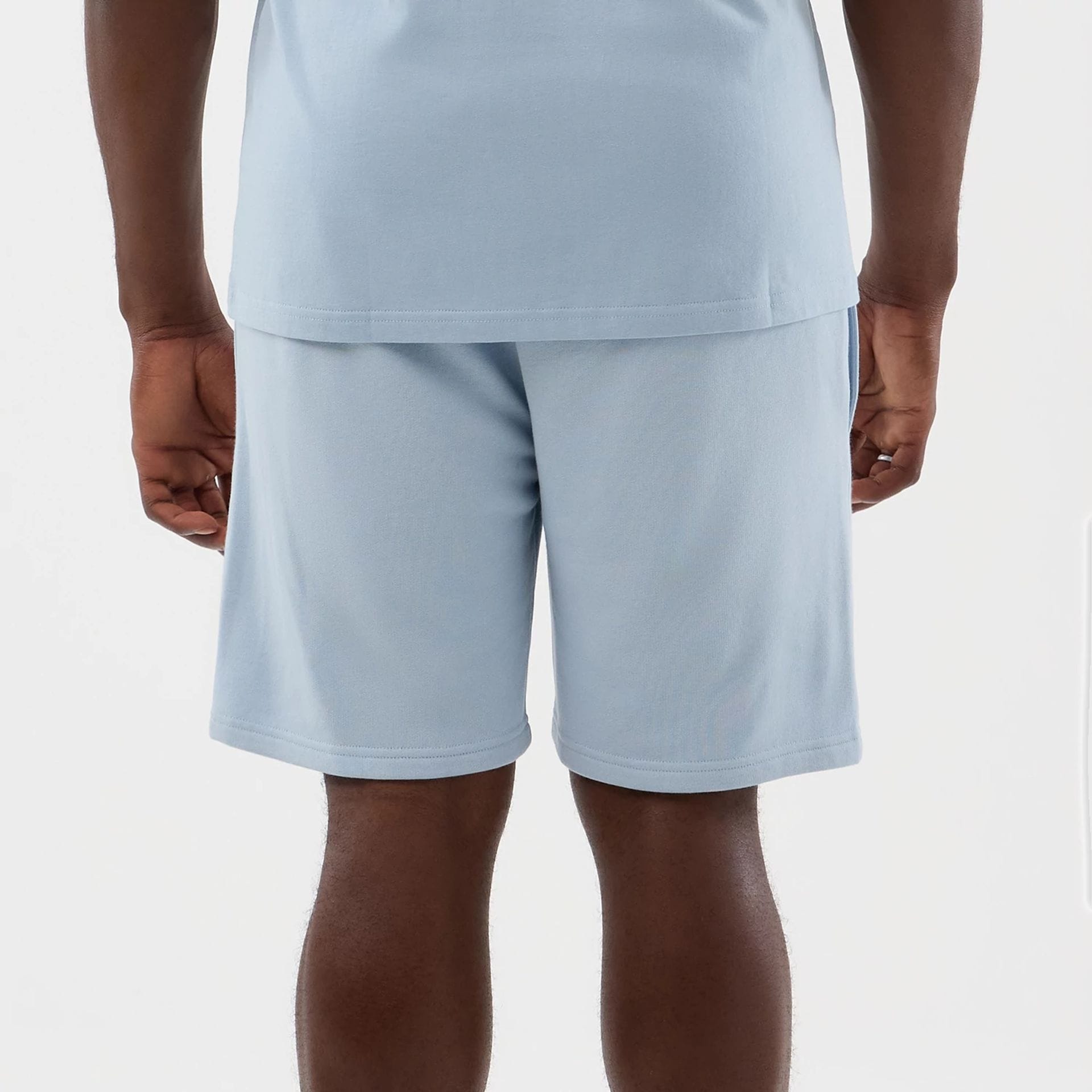 The model is wearing this NBA League Essential LA Lakers Shorts in pastel blue. 5
