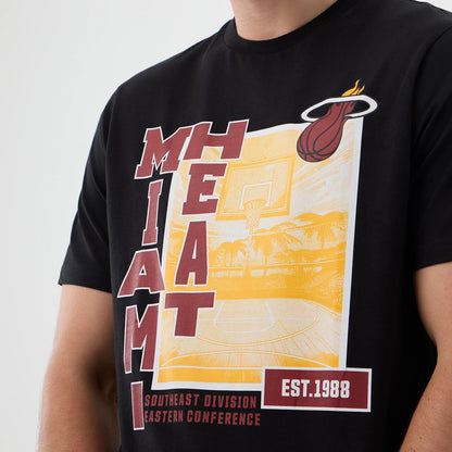 New Era Miami Heat NBA Graphic Black T-Shirt, front view showing a large yellow and maroon basketball court graphic with Miami Heat lettering running vertically, the team logo prominently printed at the top right, and EST. 1988 in on the bottom left.