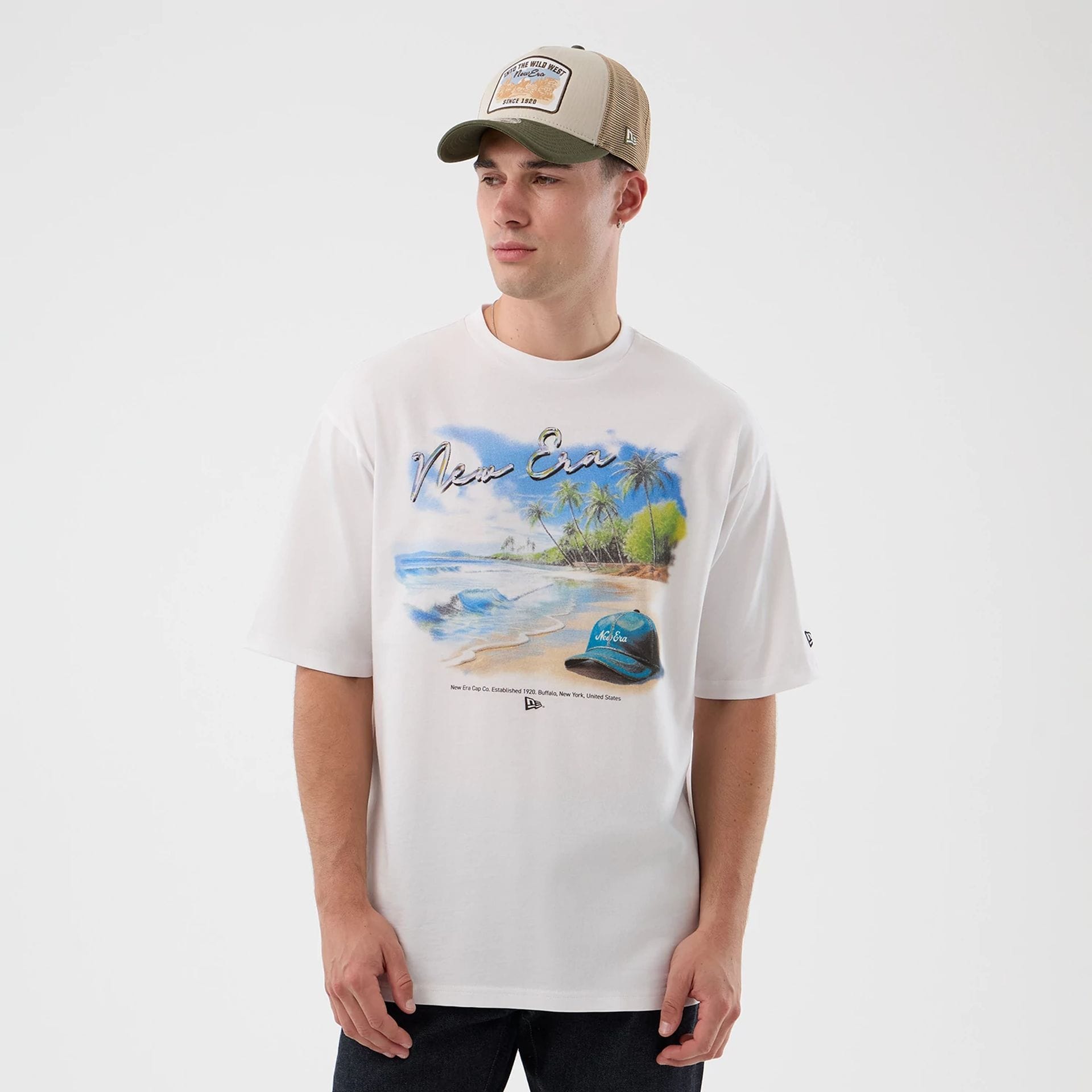 The model is wearing this New Era Beach Graphic Oversized T-Shirt in white. 3