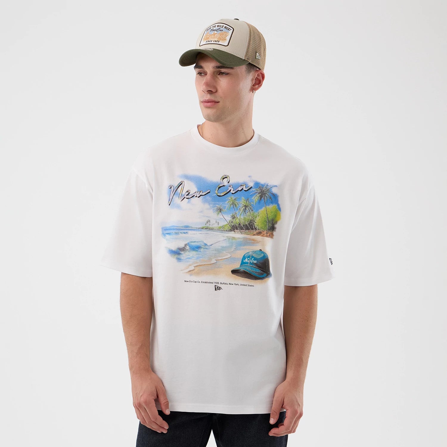The model is wearing this New Era Beach Graphic Oversized T-Shirt in white. 3