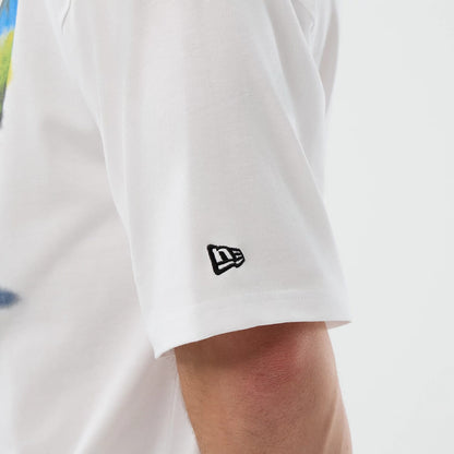 The model is wearing this New Era Beach Graphic Oversized T-Shirt in white. 7