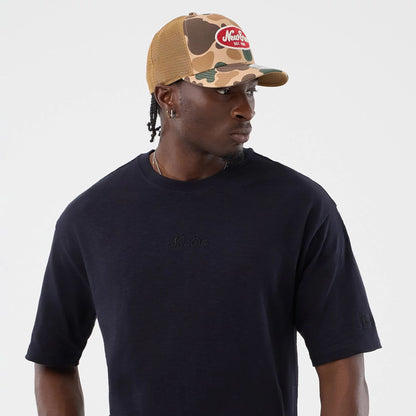 The model is wearing this New Era Slub Oversized T-Shirt in navy. 6