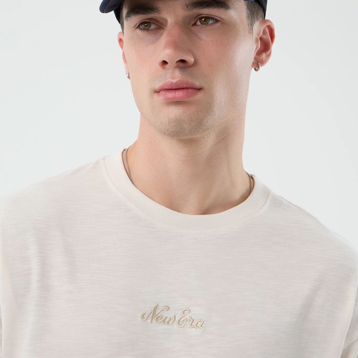 The model is wearing this New Era Slub Oversized T-Shirt in open white. 3
