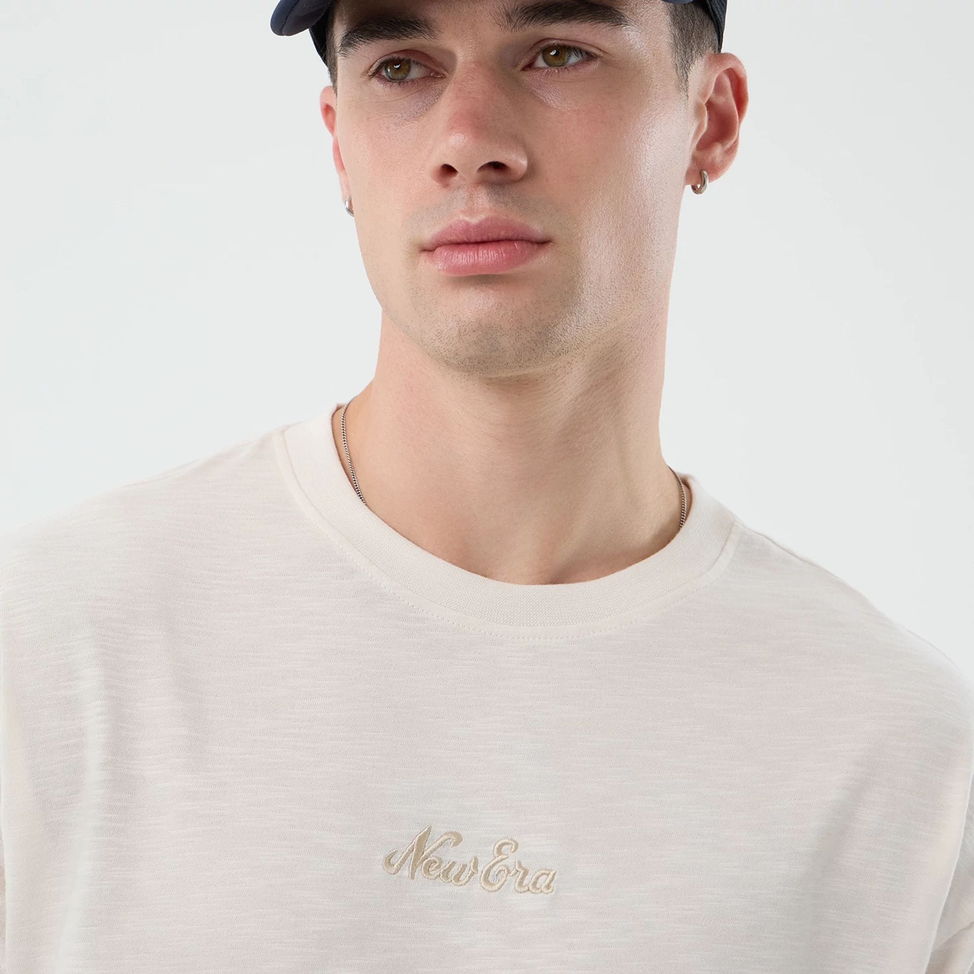 The model is wearing this New Era Slub Oversized T-Shirt in open white. 3