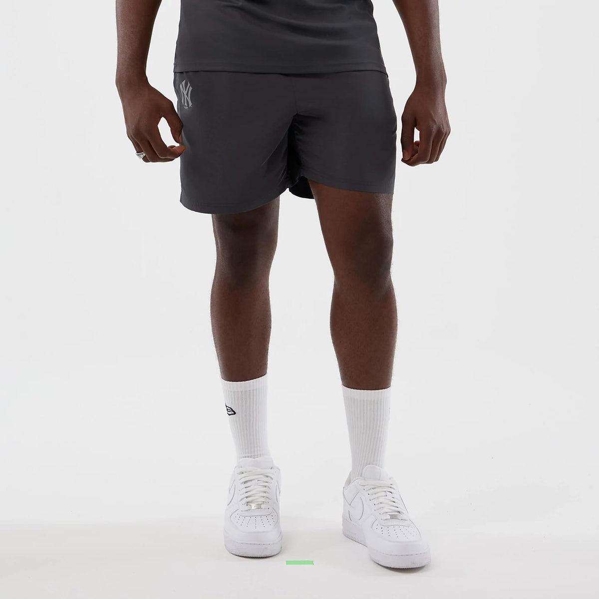 The model is wearing this MLB Core Plus New York Yankees Shorts in dark grey. 1