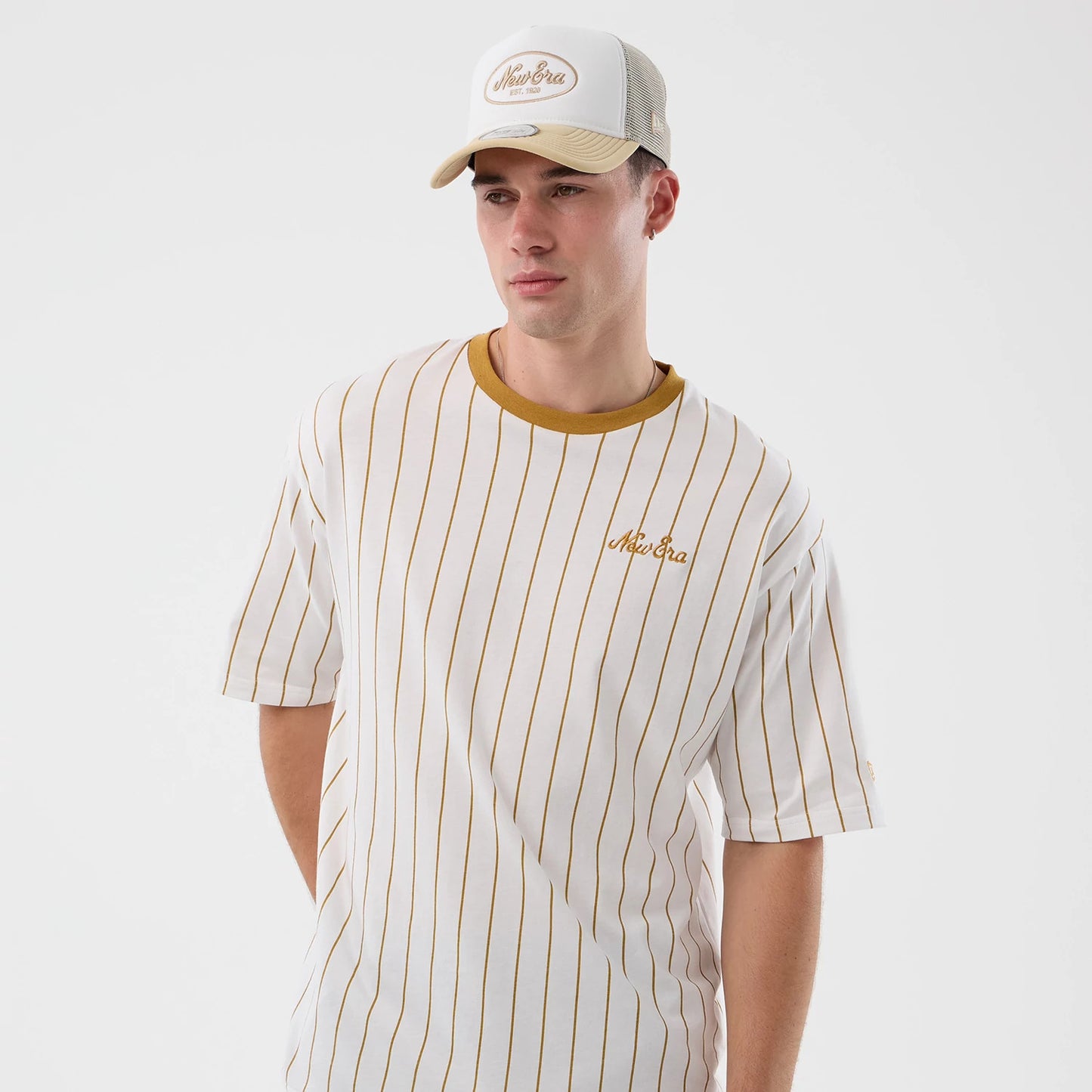 The model is wearing this New Era Pinstripe Oversized T-Shirt in white. 3