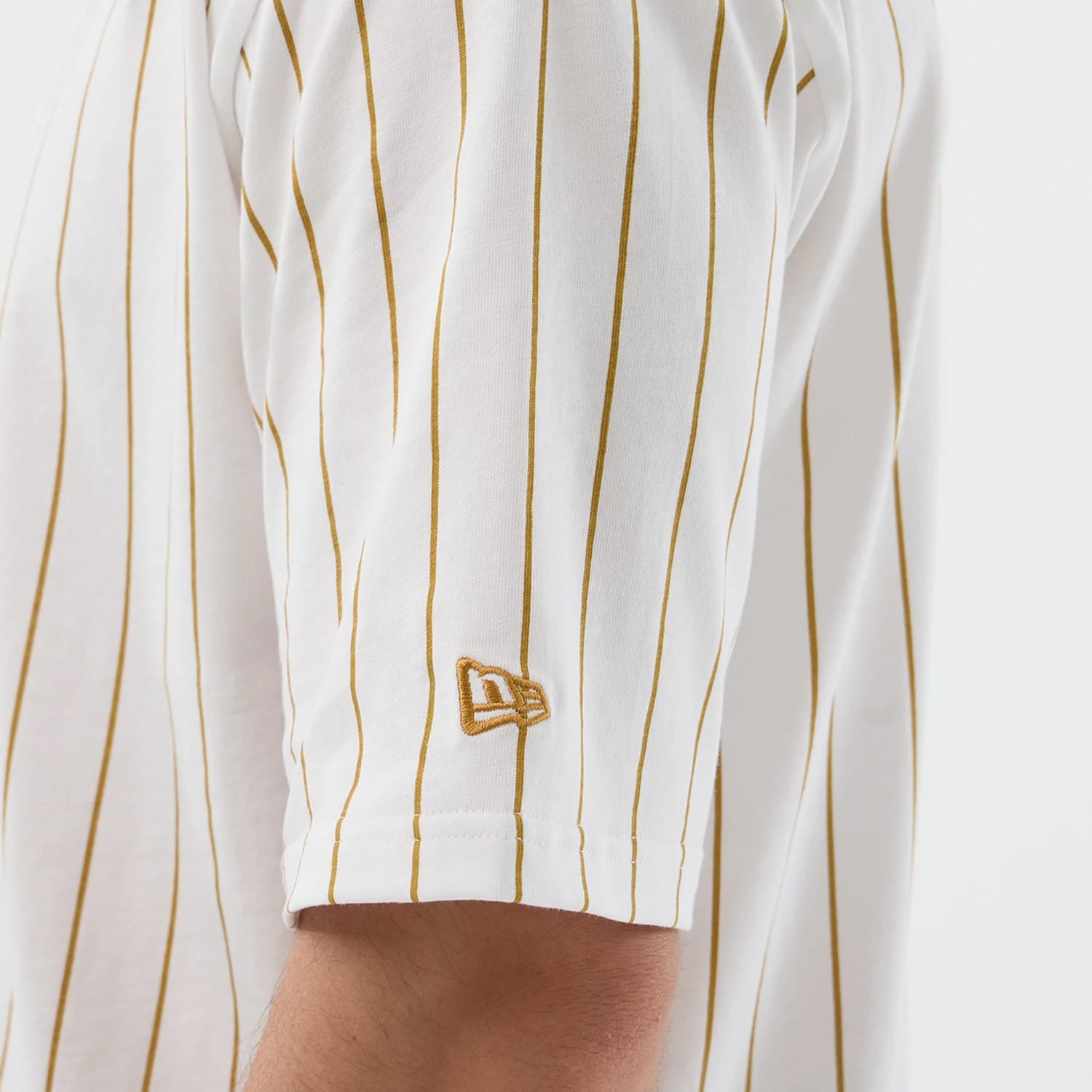 The model is wearing this New Era Pinstripe Oversized T-Shirt in white. 5