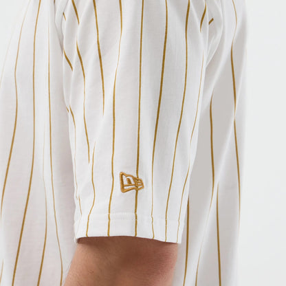 The model is wearing this New Era Pinstripe Oversized T-Shirt in white. 5