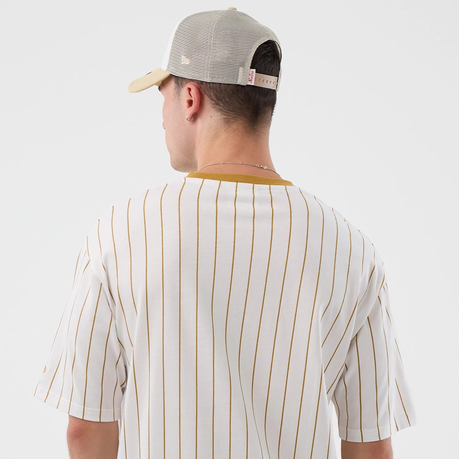 The model is wearing this New Era Pinstripe Oversized T-Shirt in white. 7