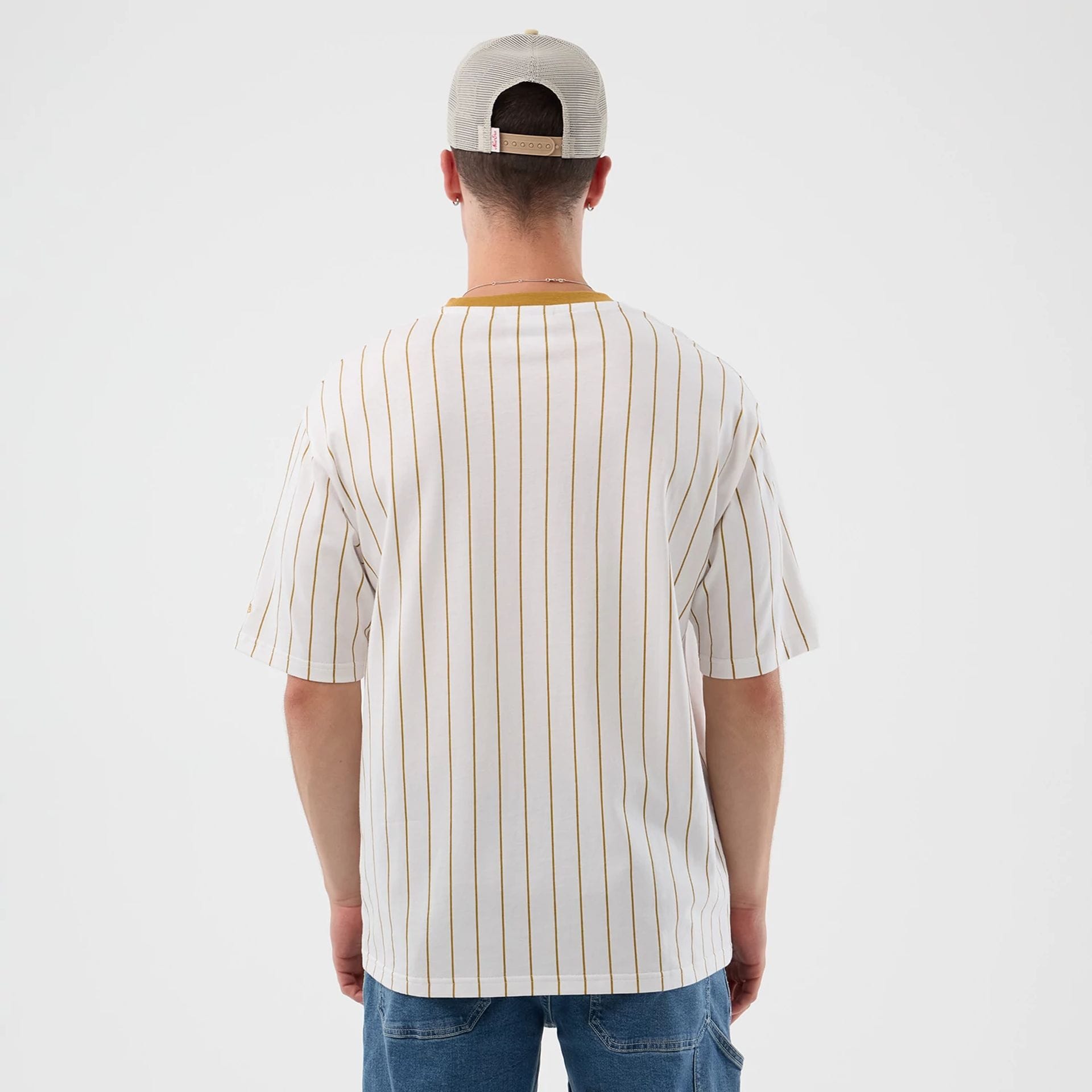 The model is wearing this New Era Pinstripe Oversized T-Shirt in white. 2