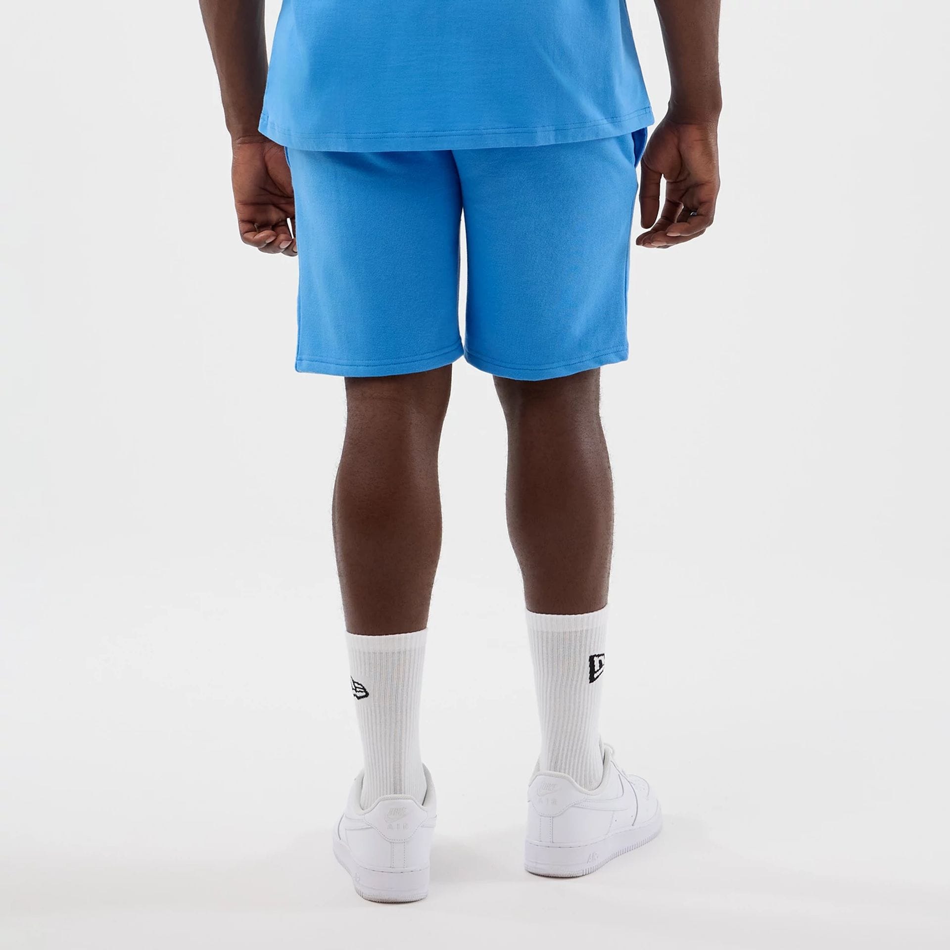 The model is wearing this MLB League Essential New York Yankees Shorts in pastel blue. 2