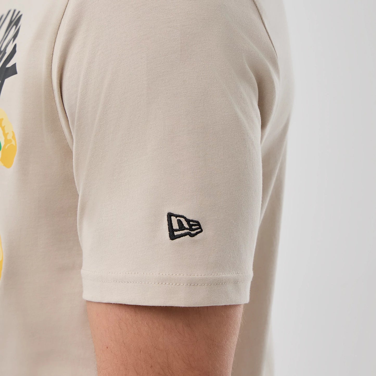 The model is wearing this New Era Pizza Graphic T-Shirt in light beige. 7