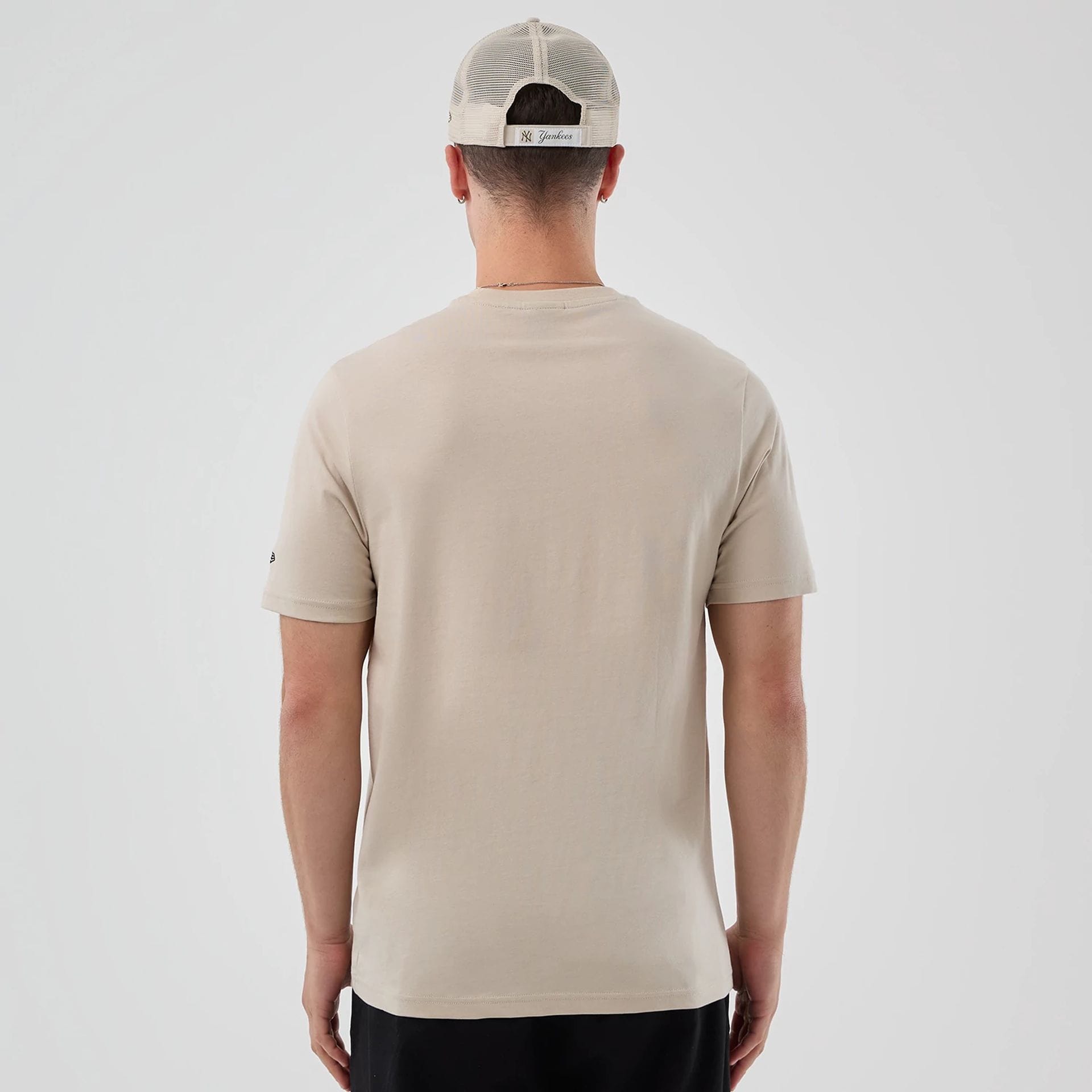 The model is wearing this New Era Pizza Graphic T-Shirt in light beige. 2