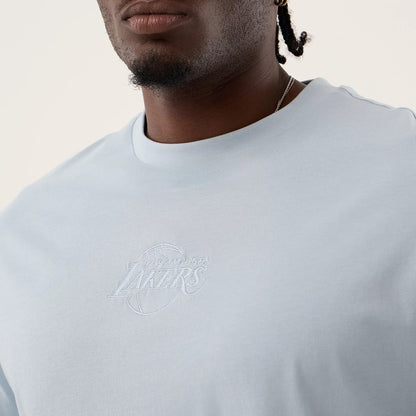 The model is wearing this NBA League Essential LA Lakers Oversized T-Shirt in pastel blue. 6