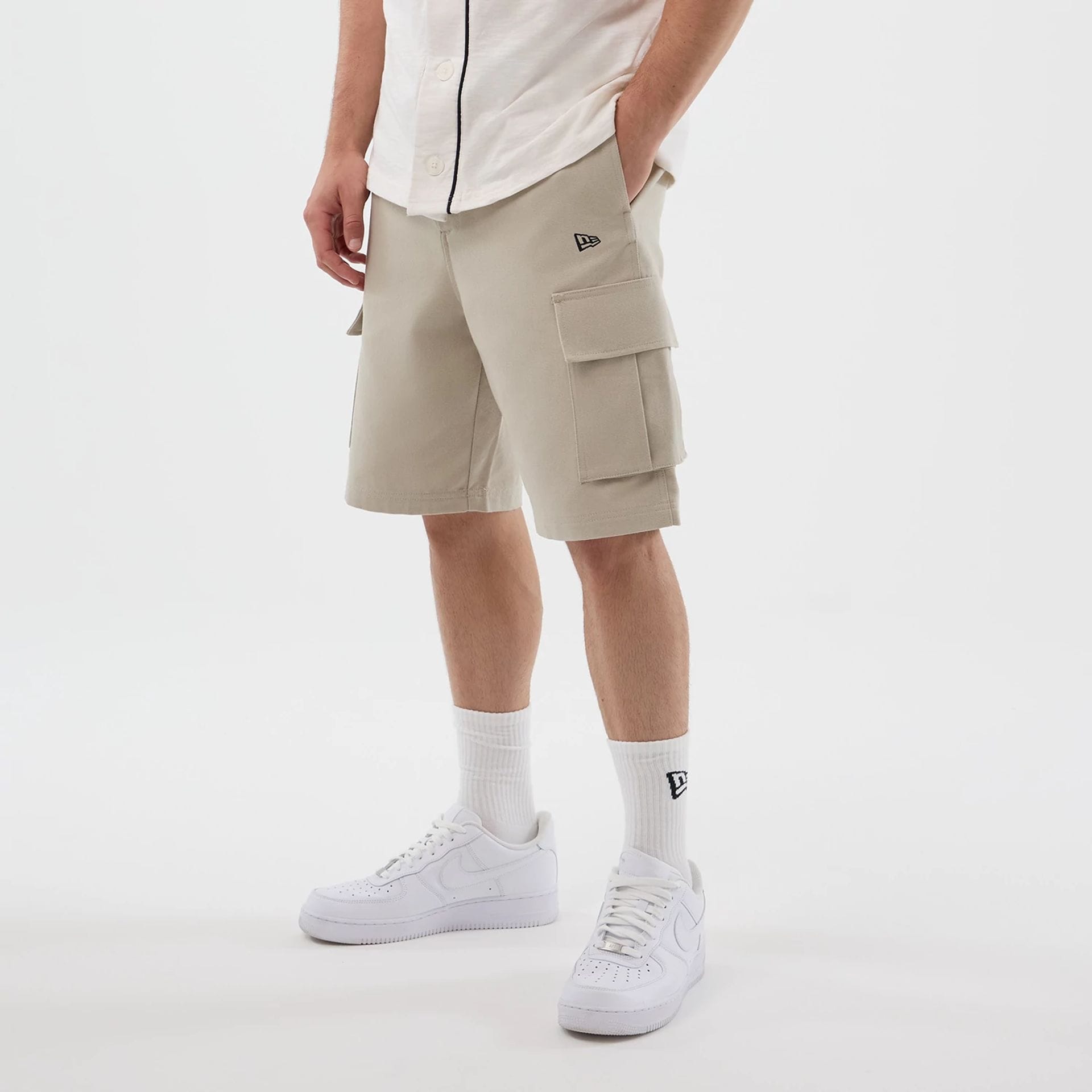 The model is wearing this New Era Cargo Shorts in light beige. 2