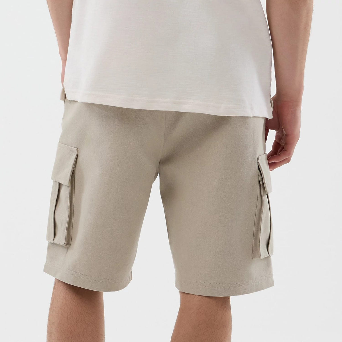 The model is wearing this New Era Cargo Shorts in light beige. 6