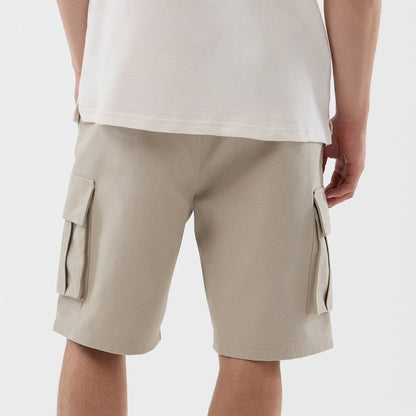 The model is wearing this New Era Cargo Shorts in light beige. 6